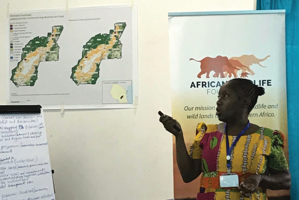 A woman gives a presentation in Tanzania for the African Wildlife Foundation