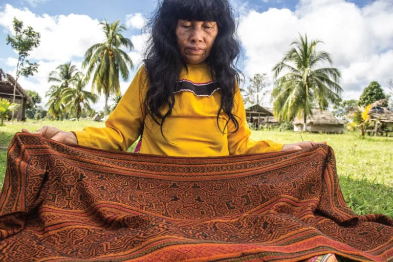Woman displays a woven cloth Woman displays a woven cloth