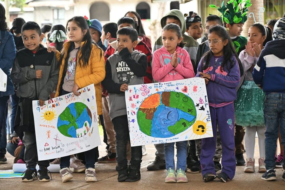 Students in the town of El Lobo present posters on keeping the Earth clean and healthy as part of the annual Fiesta de la Tierra