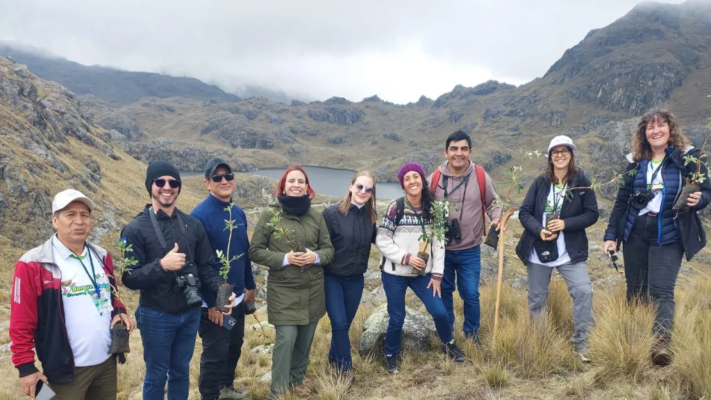 people holding tree saplings in Peru people holding tree saplings in Peru