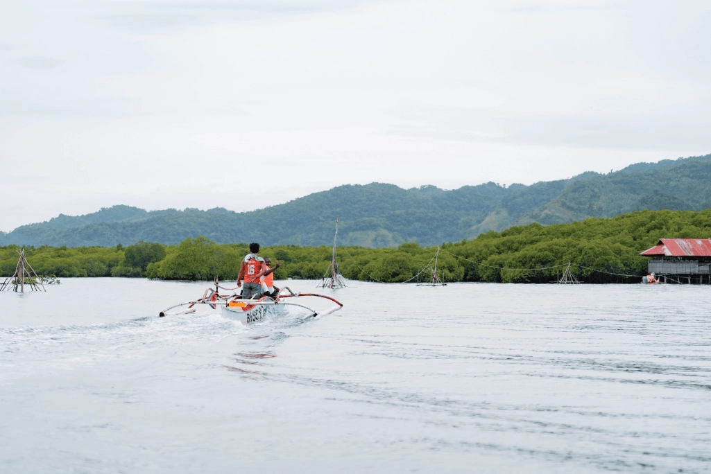 Men in a canoe, check fishing traps Men in a canoe, check fishing traps